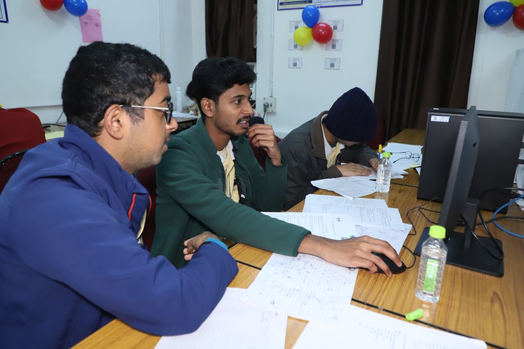 Three students discussing a programming problem